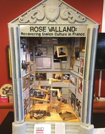 a display case with pictures and information about the history of rose valland in france