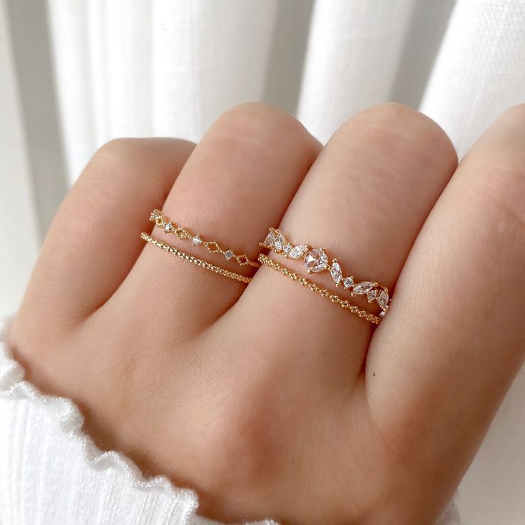 This lovely ring centers on an eye-catching round crystal, finished with marquise crystals and a beaded pattern band. Type: Adjustable ring (approx. size 6) Main material: Rose Gold, Rhodium, 16k Gold Plated on Brass,  Cubic Zirconia Need some jewelry inspiration? Follow us on Instagram  @statementGrey Fine Jeweled Rings, Adjustable Sparkling Rings For Wedding, Dainty Round Rhinestone Jewelry, Fine Jewelry Wedding Ring With Rhinestones, Adjustable Crystal Gold Rings, Crystal Rhinestone Promise Ring, Dainty Sparkling Promise Ring, Fine Crystal Ring With Sparkling Stones, Wedding Rings With Rhinestones