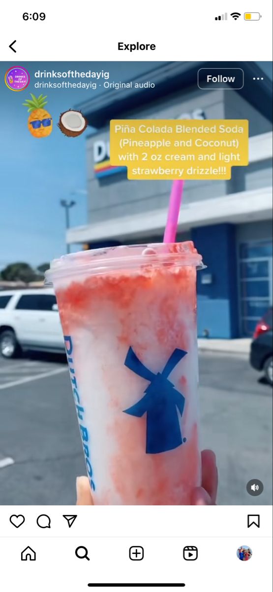 someone holding up a drink in front of a building with an instagramtion message