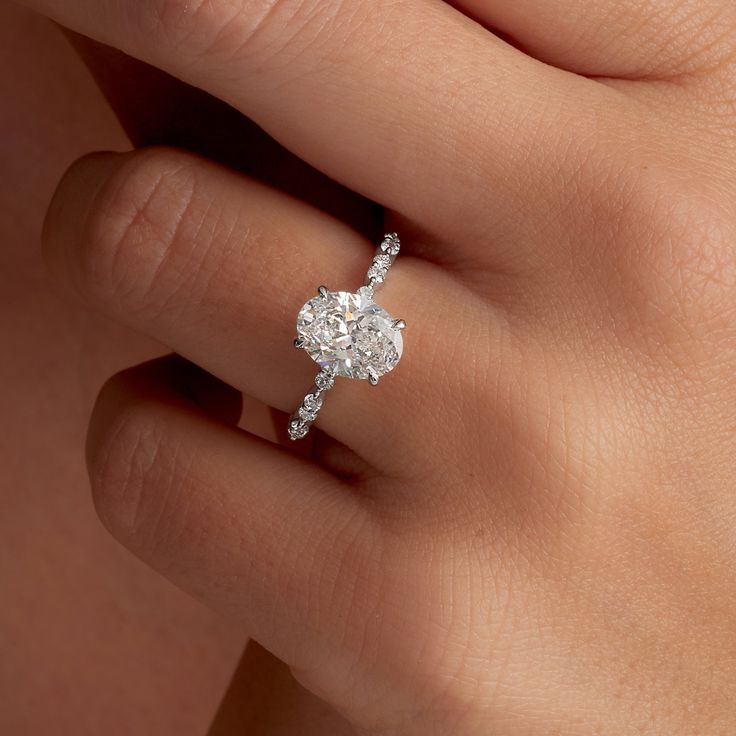 a woman's hand with a diamond ring on it