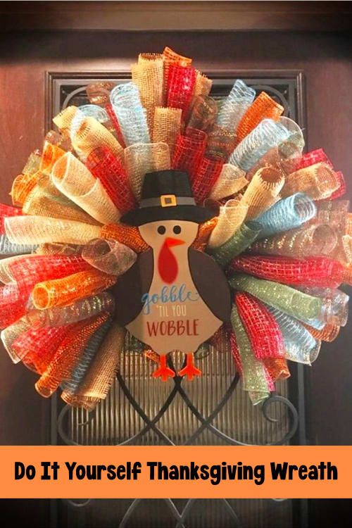 a wreath with a turkey wearing a top hat is hanging on the front door frame