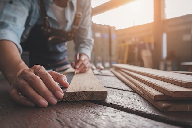 a person is working on some wood planks