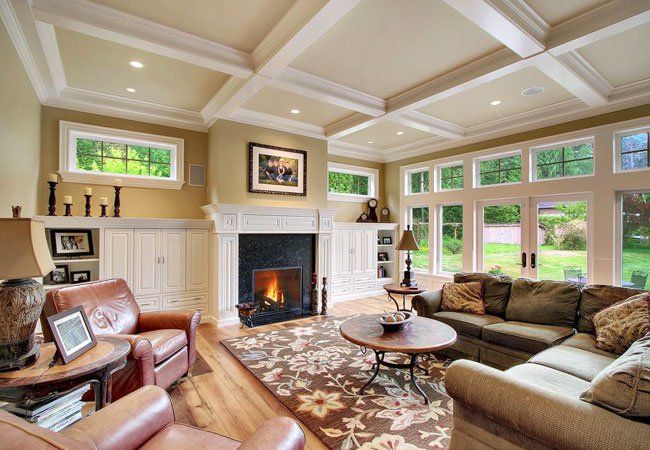 a living room filled with furniture and a fire place in the middle of a room