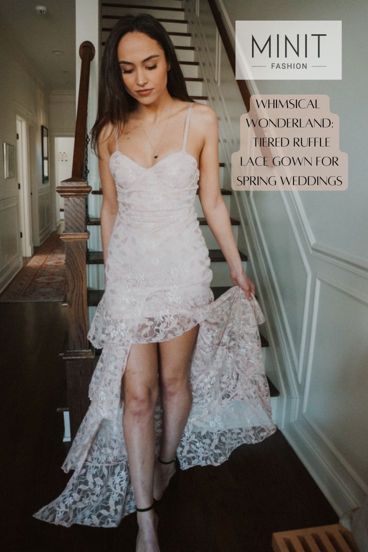 a woman in a white dress is walking down the stairs