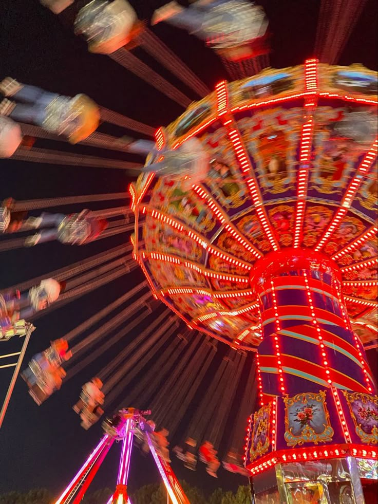 the carnival rides are brightly lit up at night