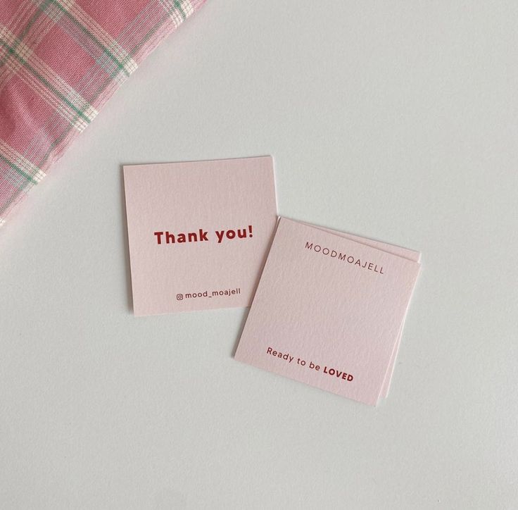 two pink cards with the words thank you on them