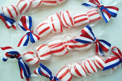 red, white and blue candies wrapped in cellophane with bows on them