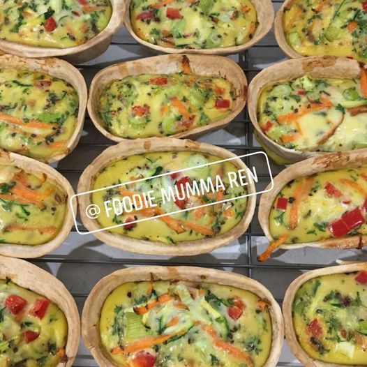 there are many different types of food in the trays on the rack together, including broccoli and other veggies