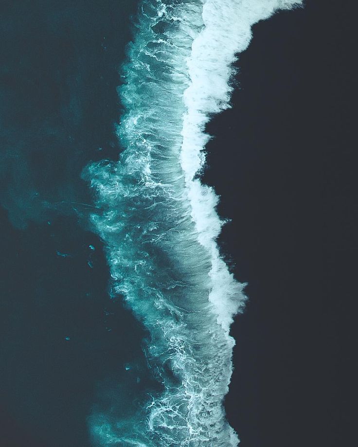 an aerial view of the ocean with waves