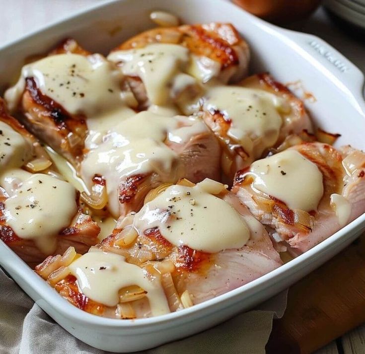 a casserole dish filled with meat covered in sauce and melted cheese on top