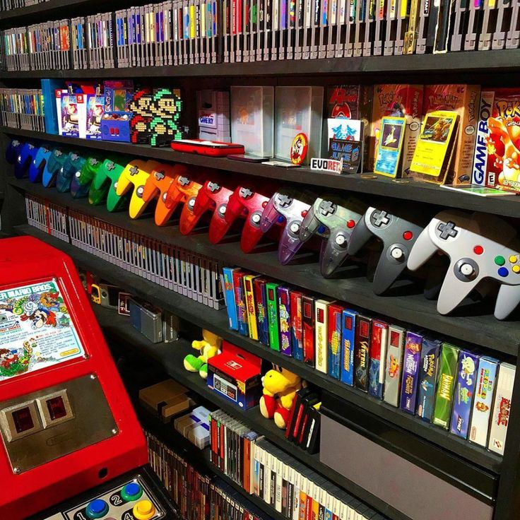 there are many video game machines on the shelves in this store that is filled with games