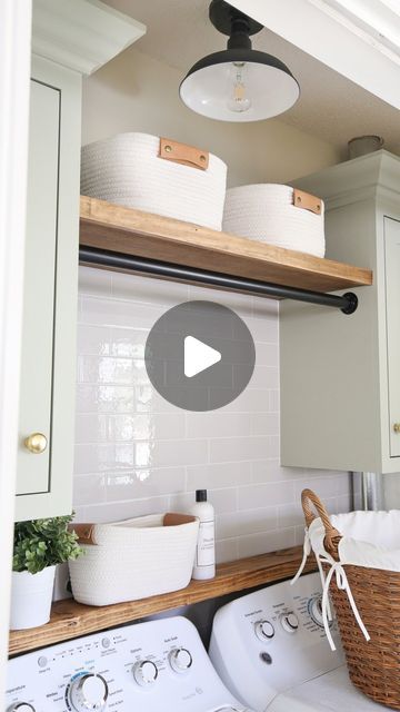 a washer and dryer sitting in a kitchen next to a shelf with baskets on it