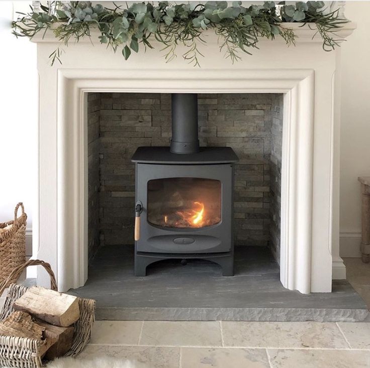 a fireplace with a wood burning stove in it