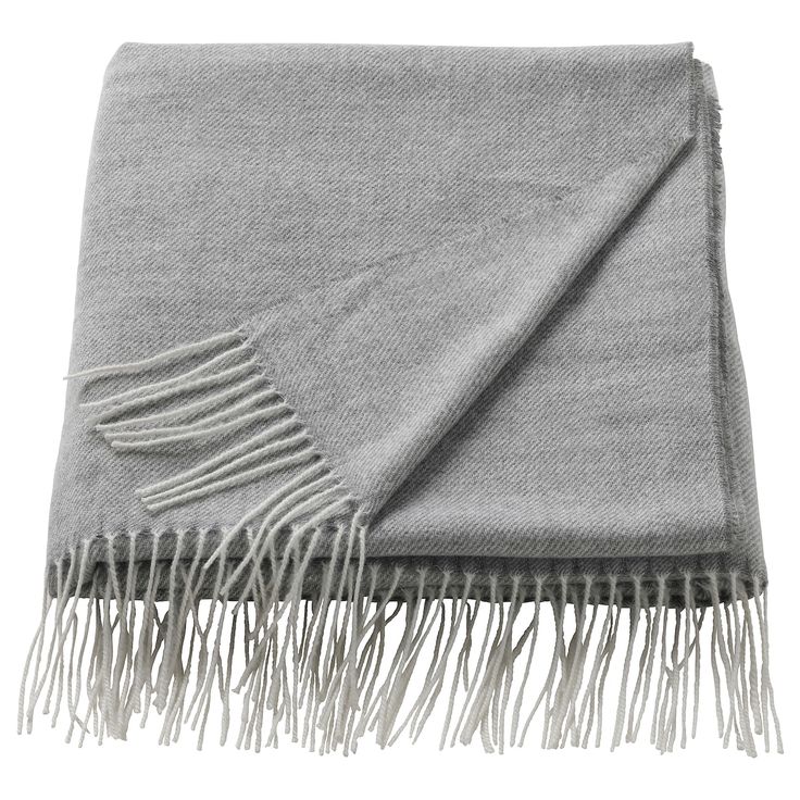 a gray blanket with fringes on it