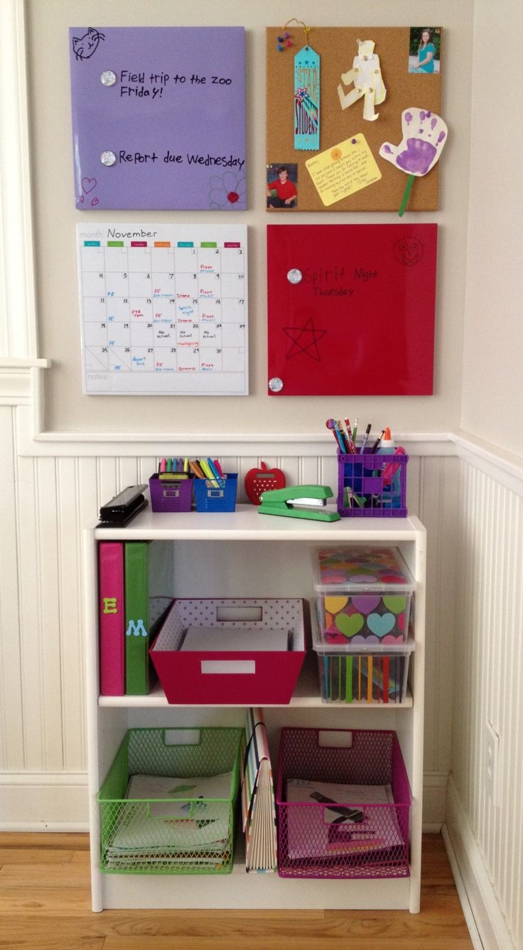 a white book shelf filled with lots of books and crafting supplies on top of a hard wood floor