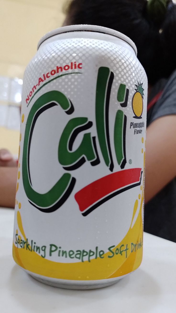 a can of cali sparkling pineapple soft drink sitting on top of a table