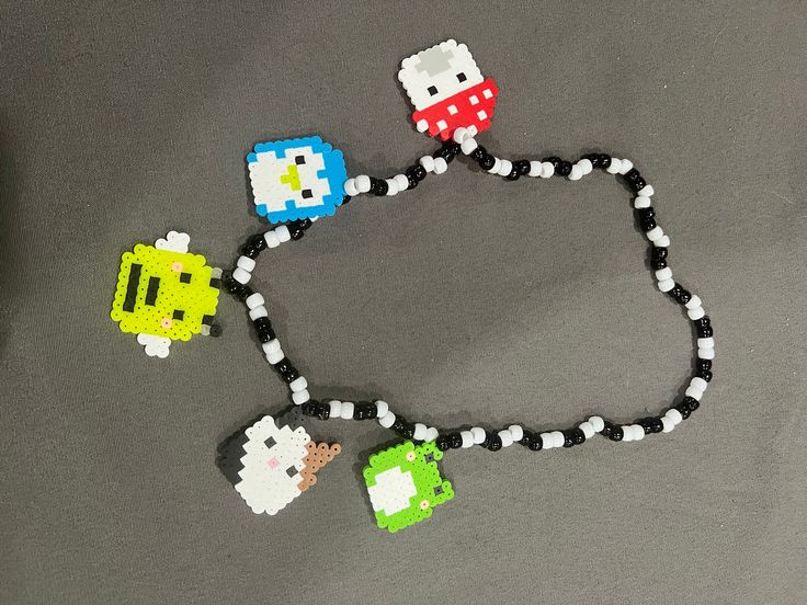 Squishmallow perler chain with multiple squishmallows! Can change the colors of the necklace beads or squishmallows if requested. Perler Chain, Handmade White Kawaii Necklace, Playful Letter Beads Jewelry For Crafting, Fun Crafting Jewelry With Letter Beads, Fun Jewelry For Crafting With Letter Beads, Fun Letter Beads Jewelry For Crafting, Playful White Beaded Chain Jewelry, Kawaii Letter Beads Jewelry For Gift, Kawaii Jewelry With Letter Beads For Gift