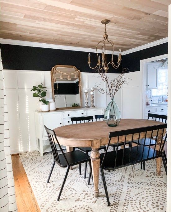 a dining room table with four chairs and a chandelier hanging from the ceiling