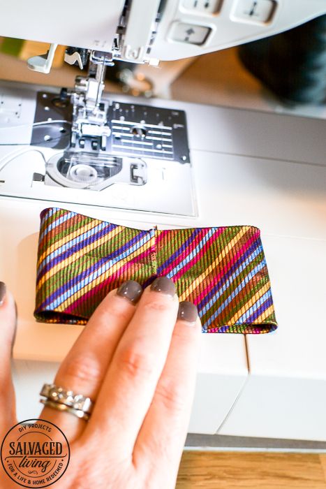 a person using a sewing machine to sew a tie