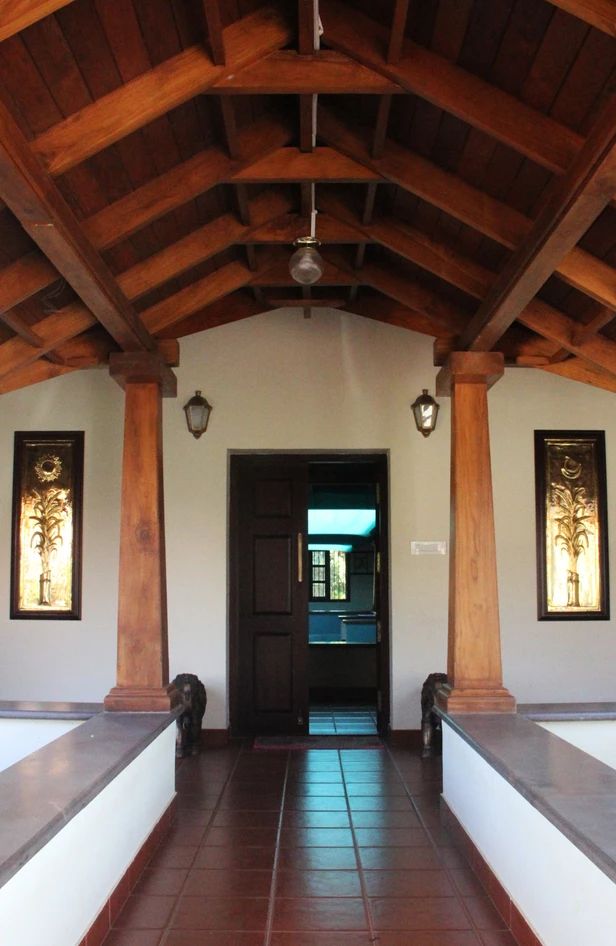 an entry way to a house with wooden pillars