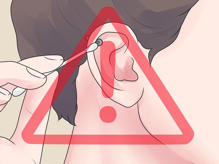 a woman is cutting her hair in front of a red triangle with the word stop on it