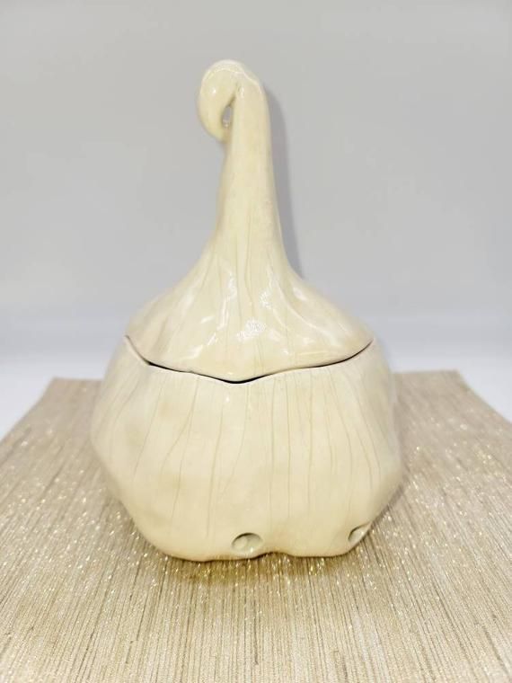 a white vase sitting on top of a mat