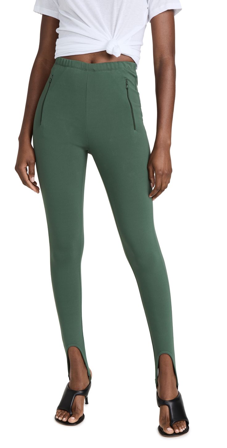 Fabric: Mid-Weight, Activewear Jersey Elastic Stirrup Straps At Cuffs High-Rise Silhouette Covered Elastic Waistband Zip Front Pockets Shell: 65% Viscose/30% Polyamide/5% Elastane Hand Wash Or Dry Clean Made In Portugal Measurements Measurements From Size S Rise: 10.75In / 27Cm Inseam: 30.75In / 78Cm | Wardrobe NYC Stirrup Legging Fitted Elastane Bottoms With Zipper Closure, Versatile Fitted Activewear With Tapered Leg, Fitted Bottoms With Elastic Side Panels For Fall, Stretch Elastane Bottoms With Zip Fly, Stretch Bottoms With Elastic Side Panels, Stretch Tapered Leg Elastane Leggings, Stretch Leggings With Zipper For Work, Sporty Elastic Bottoms Made Of Elastane, Stretch Leggings With Zipper Closure For Work