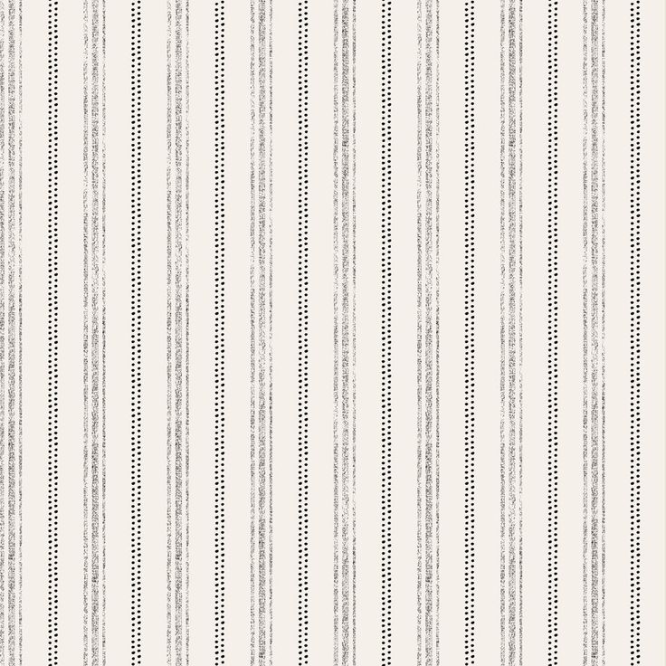 a white and grey striped wallpaper with small black dots on the bottom half of it