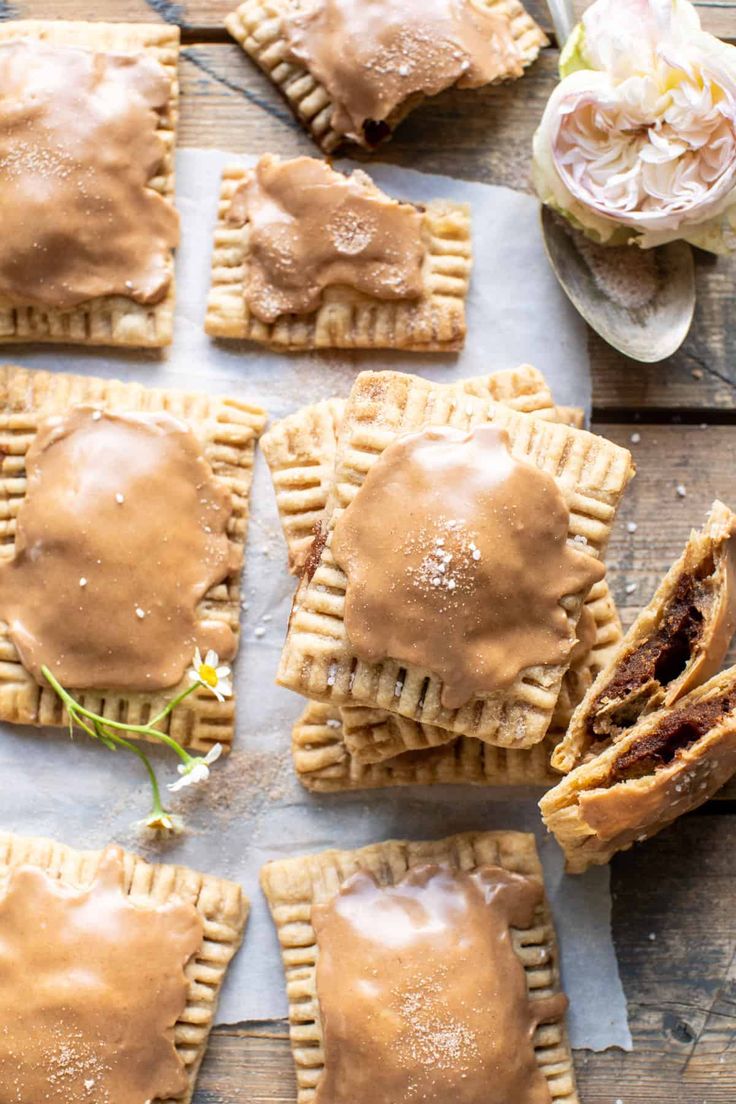 homemade hand pies with peanut butter frosting on top and flowers in the background