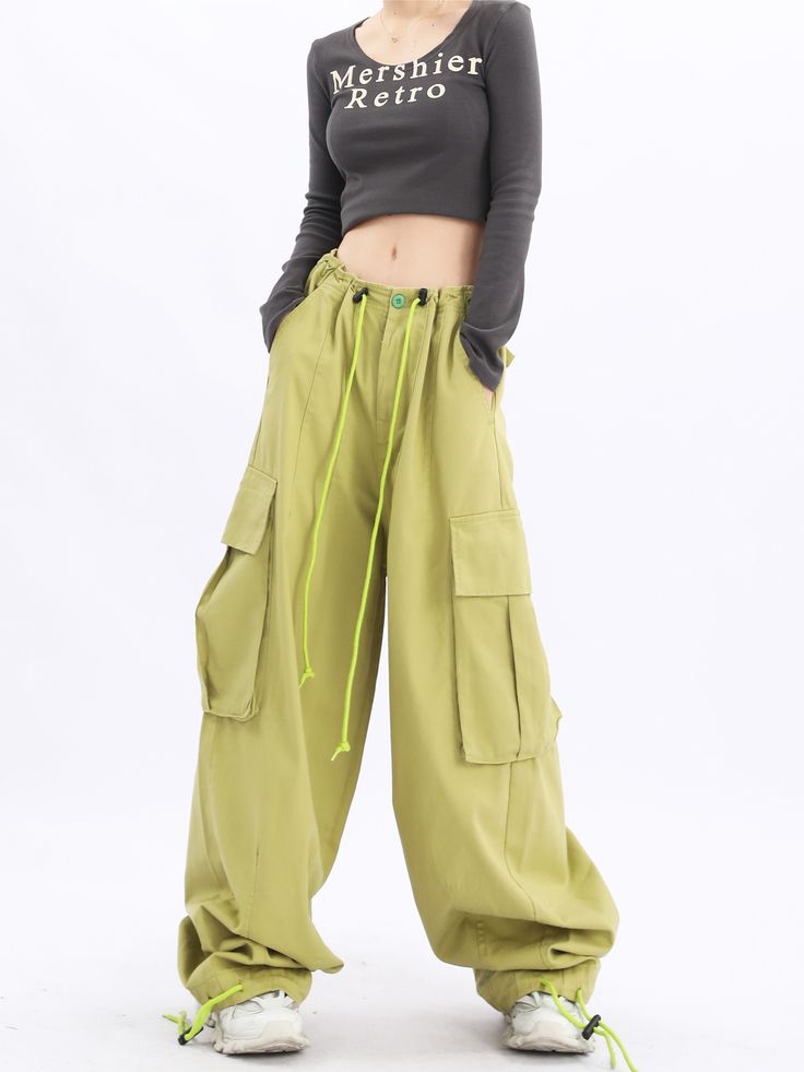 Elevate your casual look with our Oversized Baggy Cargo Pants. Featuring a trendy Y2K influence, these streetwear essentials by Acubi offer a relaxed fit, drawstring waist, and functional pockets for a fashionable and comfortable outfit. Streetwear Harem Pants With Cargo Pockets And Straight Leg, Streetwear Straight Leg Harem Pants With Cargo Pockets, Streetwear Straight-leg Harem Pants With Cargo Pockets, Hip Hop Style Pants For Outdoor Activities With Pockets, Streetwear Harem Pants With Pockets, Green Cargo Style Wide-leg Parachute Pants, Relaxed Fit Wide-leg Utility Cargo Pants, Baggy Sweatpants With Pockets For Outdoor Activities, Baggy Khaki Cargo Jeans