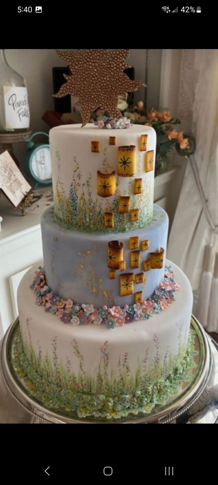 a three tiered cake sitting on top of a table