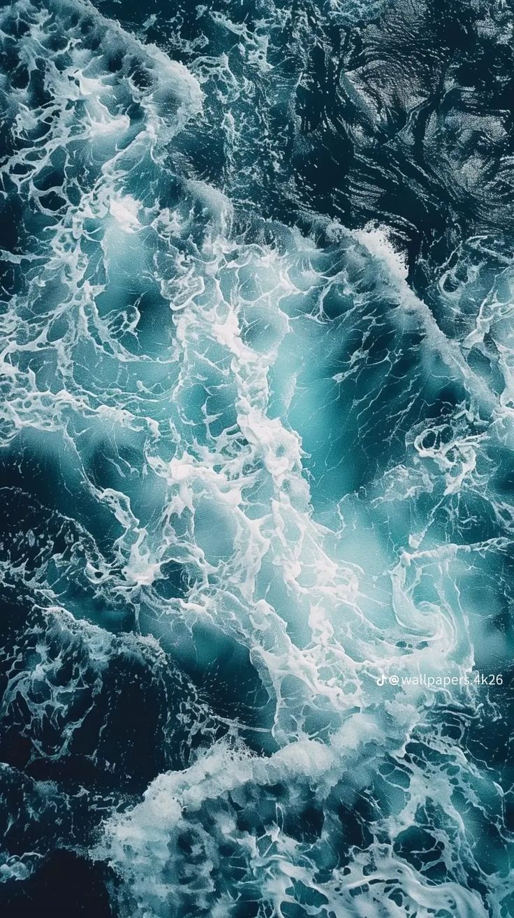 an aerial view of the ocean waves