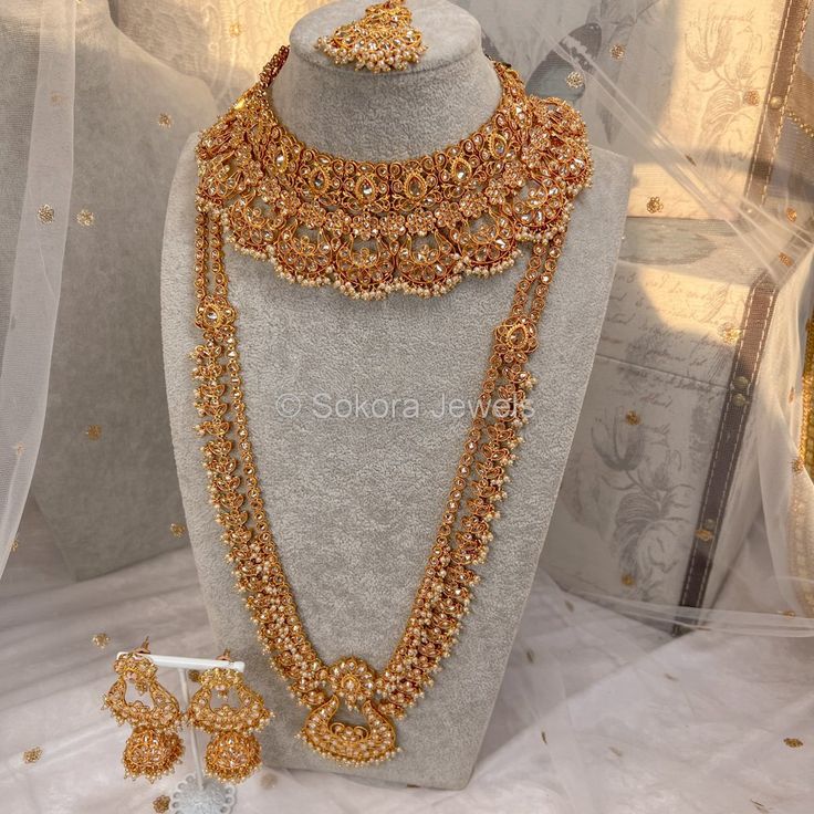 Luxury Bright gold polished champagne zircon full bridal set with small champagne pearl beads. Bridal set includes, Necklace, Long mala, Earrings and tikka This set is ready to ship as seen with gift box. Gold Kundan Sets For Reception, Gold Sets With Intricate Design For Reception, Gold Temple Jewelry Sets For Reception, Gold Kundan Lehenga For Wedding, Gold Sets With Tilla For Reception, Gold Bollywood Sets For Wedding, Bollywood Style Gold Wedding Sets, Gold Chandbali Jewelry Sets For Wedding, Gold Jewelry Sets For Diwali Reception