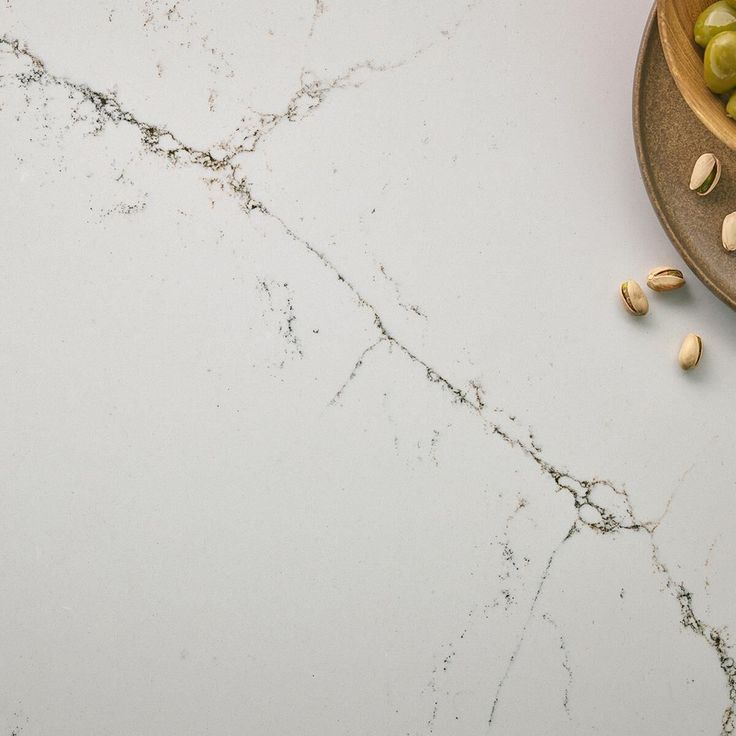 grapes and almonds on a white marble counter top