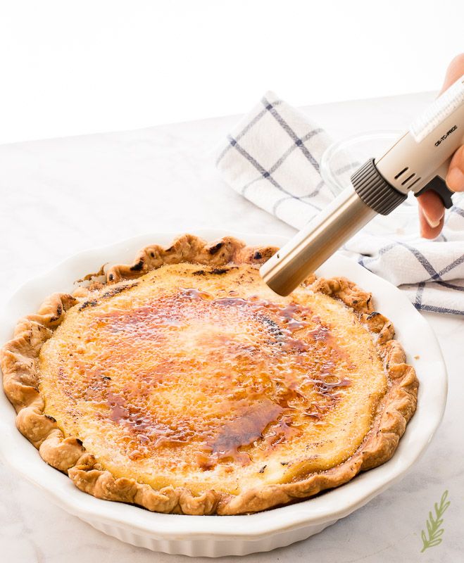 a person using a pastry mixer on top of a pie