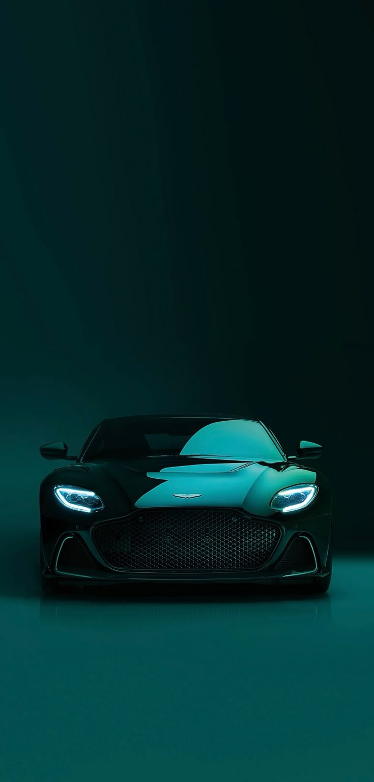 a black and blue sports car on a dark green background with the headlights turned off