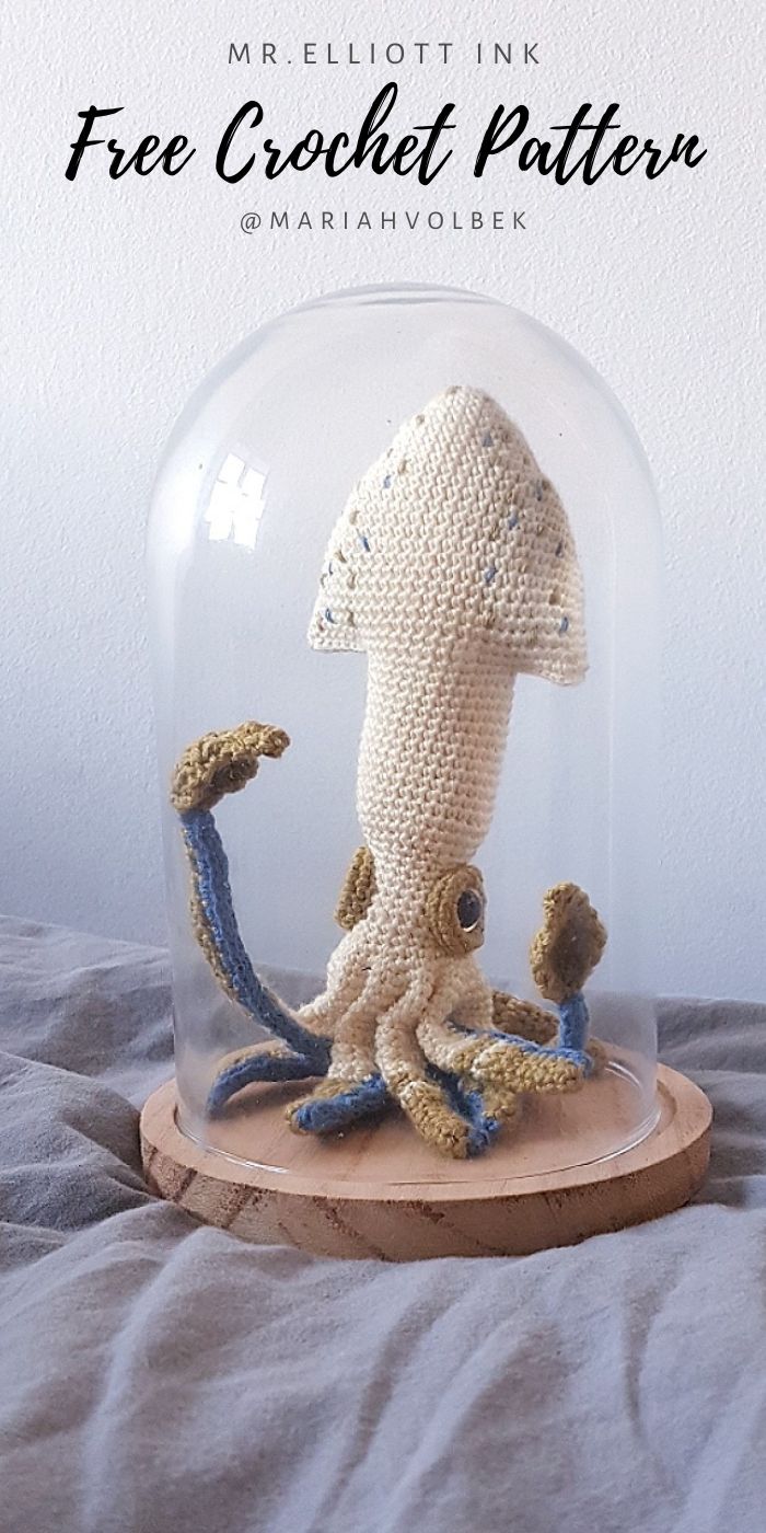 a crocheted octopus under a glass dome on a wooden base with the caption free crochet pattern