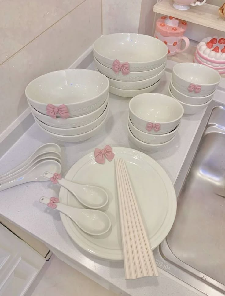 a kitchen counter topped with lots of white dishes