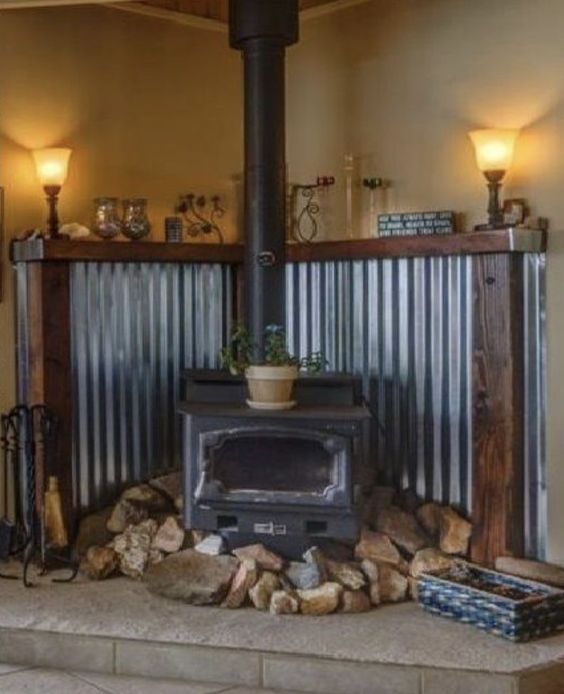 an old fashioned stove is in the middle of a room with wood and metal walls