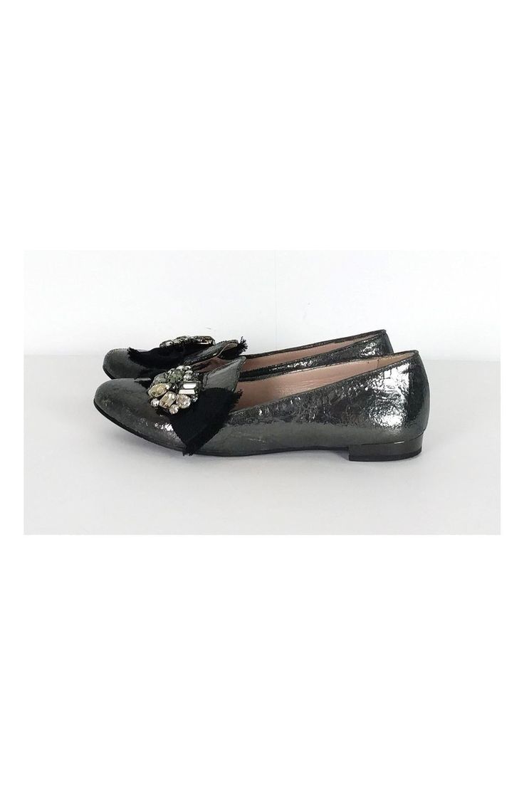 The leather of these flats has a unique crackled look. A bold rhinestone and ribbon design adorns the front. These luxe flats have all of the shimmer and glam you need. Size 6.5 (EU 36.5) Leather upper, lining & sole Made in Italy Rounded toe Crackled look to leather Rhinestone detail on front w/ ribbon Mirrored design on heel Light scuffs on toe Some outsole wear Outsole length 10" Embellished Leather Ballet Flats With Flat Heel, Leather Embellished Ballet Flats, Embellished Leather Ballet Flats, Party Loafers With Almond Toe Slip-on, Elegant Evening Ballet Flats With Textured Sole, Evening Slip-on Ballet Flats, Evening Ballet Flats With Textured Sole, Glitter Round Toe Flats For Party, Glitter Flats With Round Toe For Party