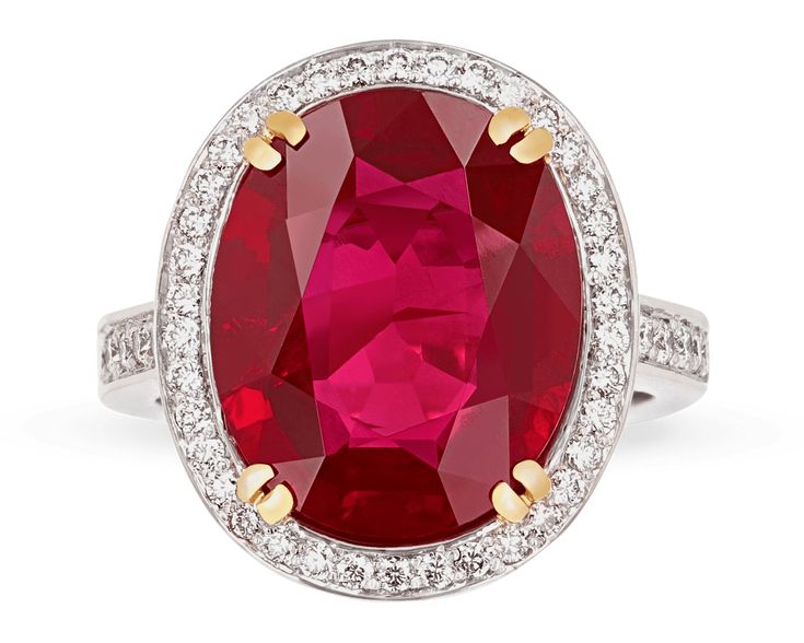 an oval shaped ruby and diamond ring with two tone gold accents on the sides, set in