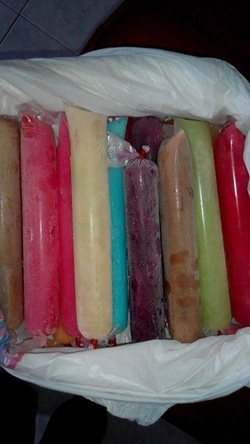 there are many different colored candles in the bag