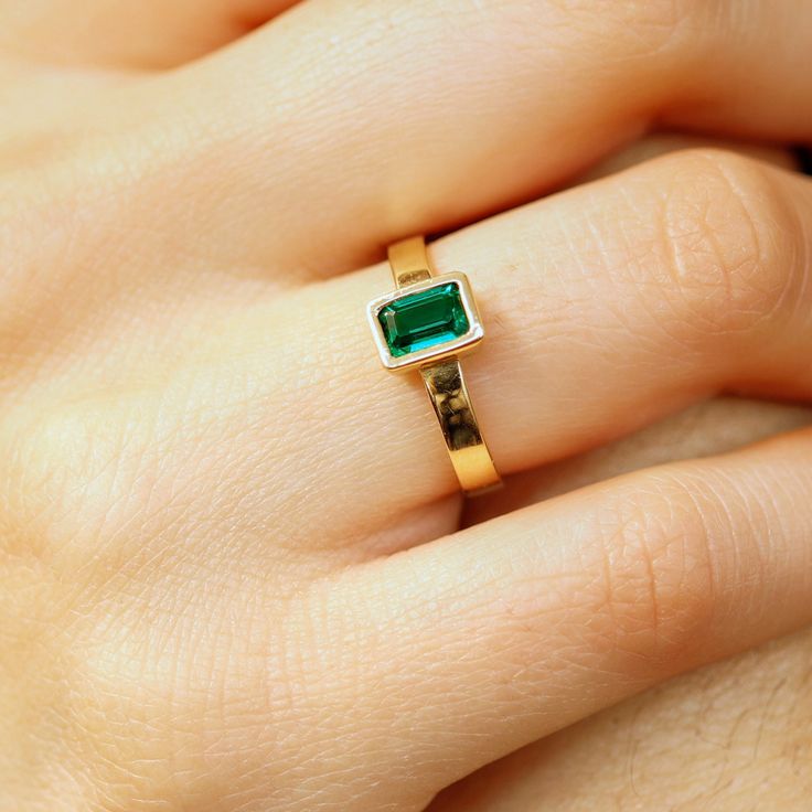 This beautiful Emerald Gold Ring was handmade in Melt'm Jewelry Design Studio in California using 14k solid yellow gold band and 6x4mm emerald cut lab grown emerald stone.  Emerald is featuring in 14k gold thick bezel setting. It's a lovely unisex ring for men and women.   DETAILS ABOUT THE RING, MATERIAL AND STONES Ring Band: 14K solid gold  Ring Band size:  3x1 mm thick flat band Gemstone: Lab grown Emerald Emerald size:   6mm x 4mm  emerald cut Yellow gold or white gold options available from Stackable Gold Emerald Cut Rings, 14k Gold Polished Emerald Promise Ring, Modern Gold Rings With Emerald, Emerald Cut Yellow Gold Ring As A Gift, Yellow Gold Emerald Promise Ring With Polished Finish, Gold Emerald Ring With Polished Finish For Promise, Gold Rings Emerald Cut For Gift, Gold Emerald-cut Emerald Ring For May Birthstone, Emerald Cut Gold Rings For Gift