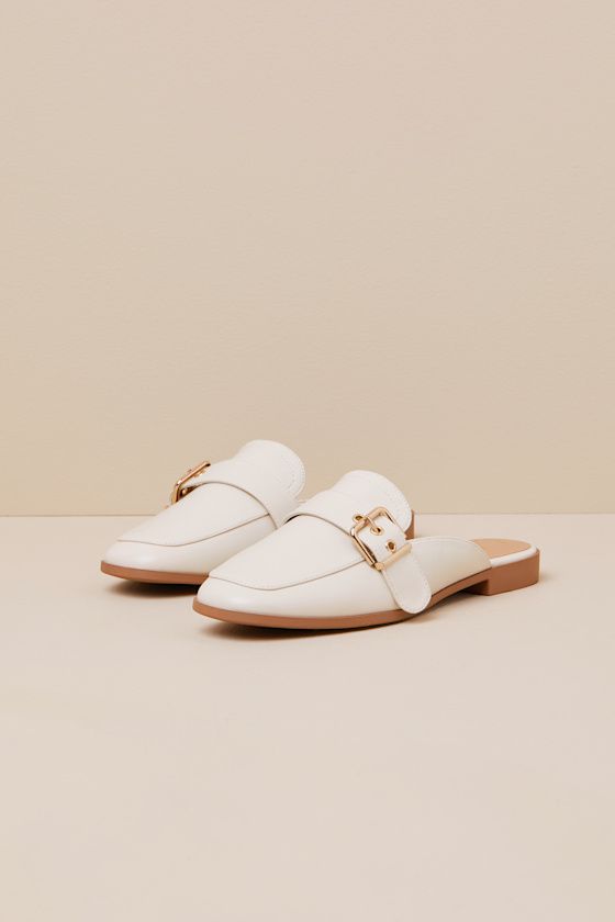 Upgrade your everyday flats with a chic new option like the Lulus Marquete Bone Buckle Mule Slides! These too-cute mules have a smooth, faux leather construction that shapes an almond toe upper and an adjustable strap with a gold buckle and matching grommets. Classic notched collar leads to a slide-on design for effortless styling. 0. 75" rubber heel. Cushioned insole. Rubber sole has nonskid markings. Man made materials. Imported. Lulus | Marquete Bone Buckle Mule Slides | Size 10. Trendy Beige Flat Mules, Chic Synthetic Flat Slip-ons, Chic Spring Flats With Buckle Closure, Elegant Beige Flat Mules, Elegant Flat Mules For Spring, Spring Faux Leather Flats, Beige Faux Leather Flats For Spring, Chic Faux Leather Flats For Spring, Spring Beige Faux Leather Flats