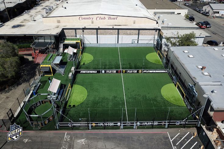 an aerial view of a soccer field in the city