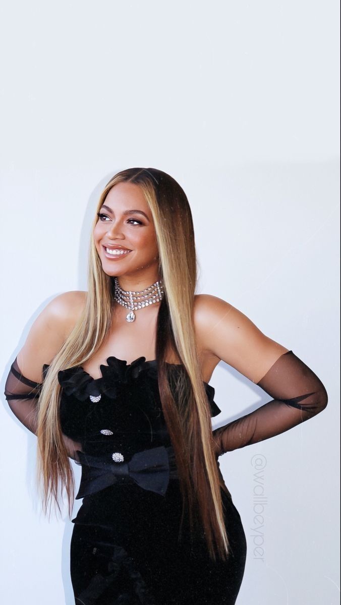 a woman with long blonde hair wearing a black dress