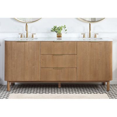 a bathroom vanity with two sinks and mirrors on the wall next to a rug in front of it