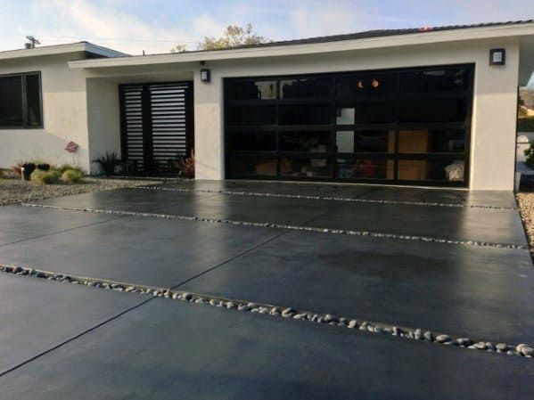 an empty driveway in front of a house