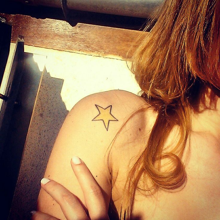 a woman with a star tattoo on her shoulder