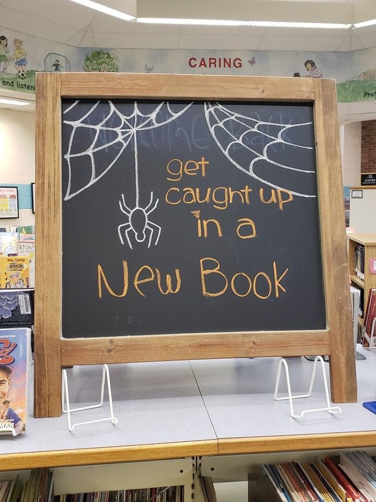 a sign that says get caught up in a new book with spider web on it